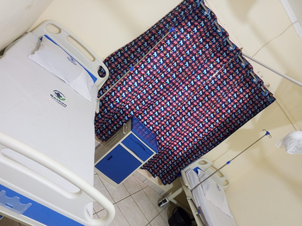 Bashan Hospital inpatient ward with branded bedding